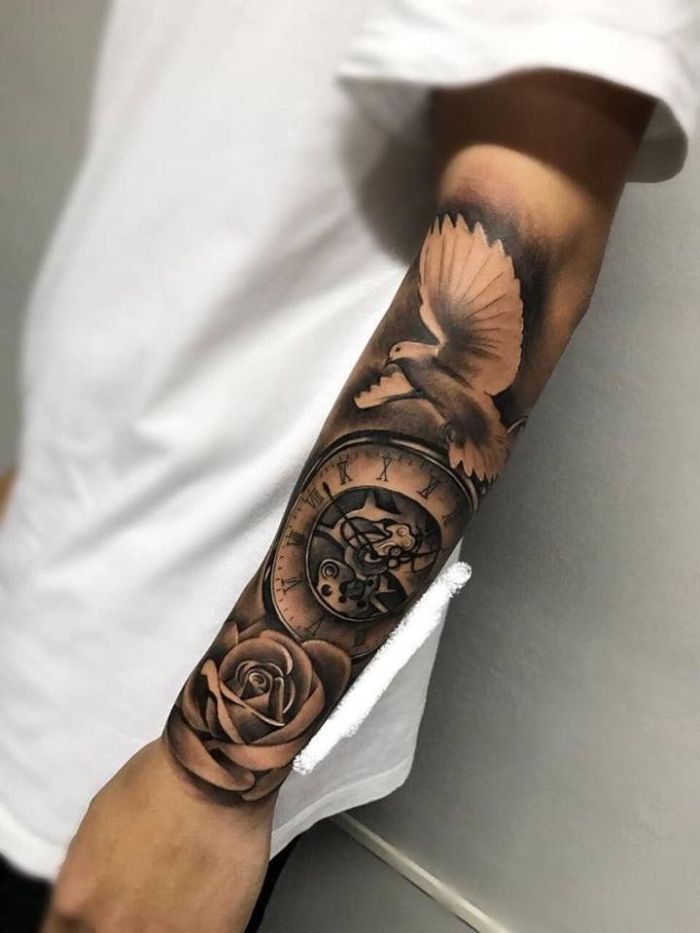 a man with a clock and rose tattoo on his arm