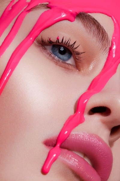 a woman's face is covered in pink liquid