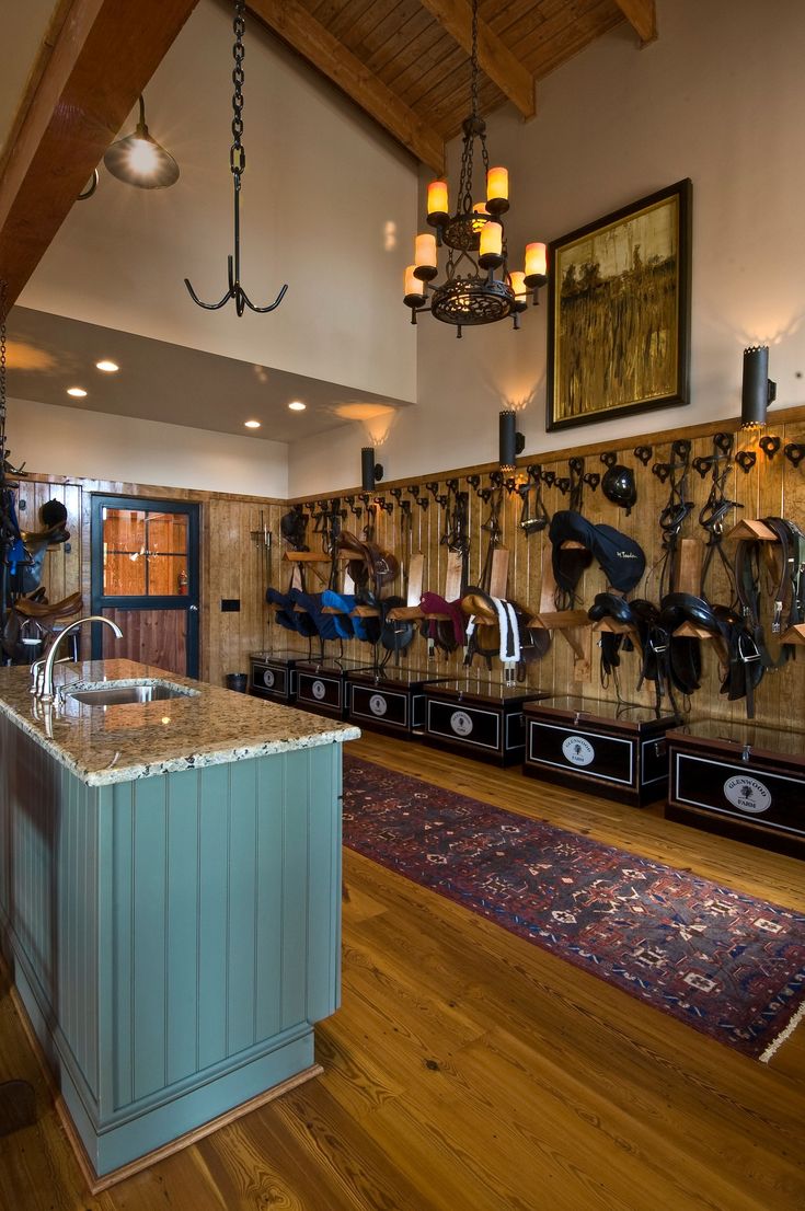 a kitchen with an island and lots of hooks on the wall