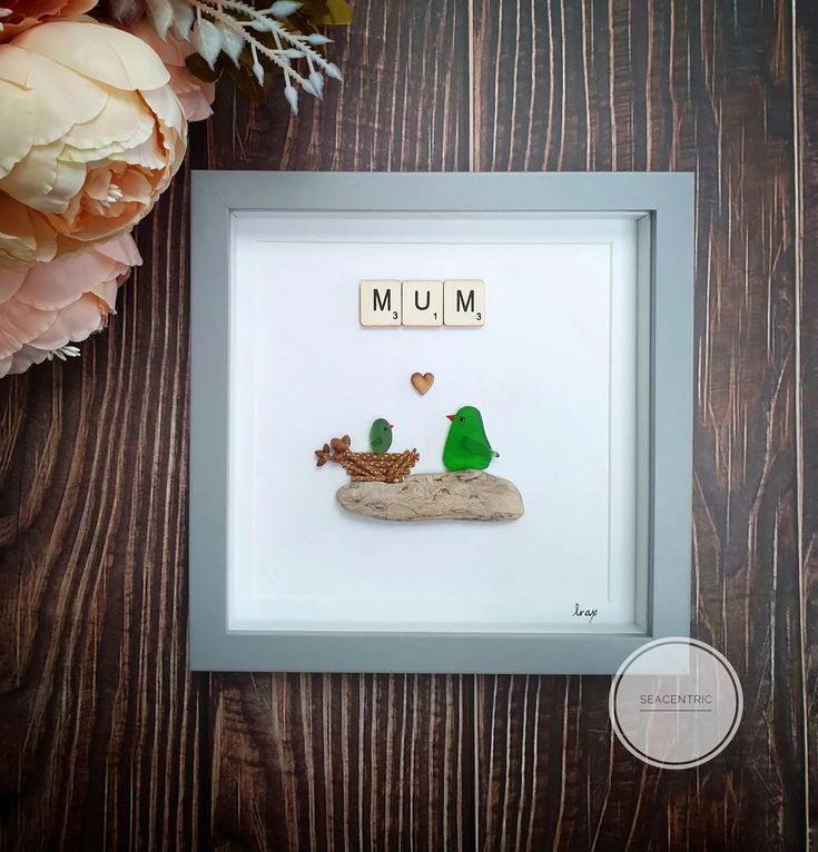 an image of a mother's day card with two birds in the sand and flowers