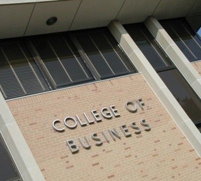 the college of business sign is on the building