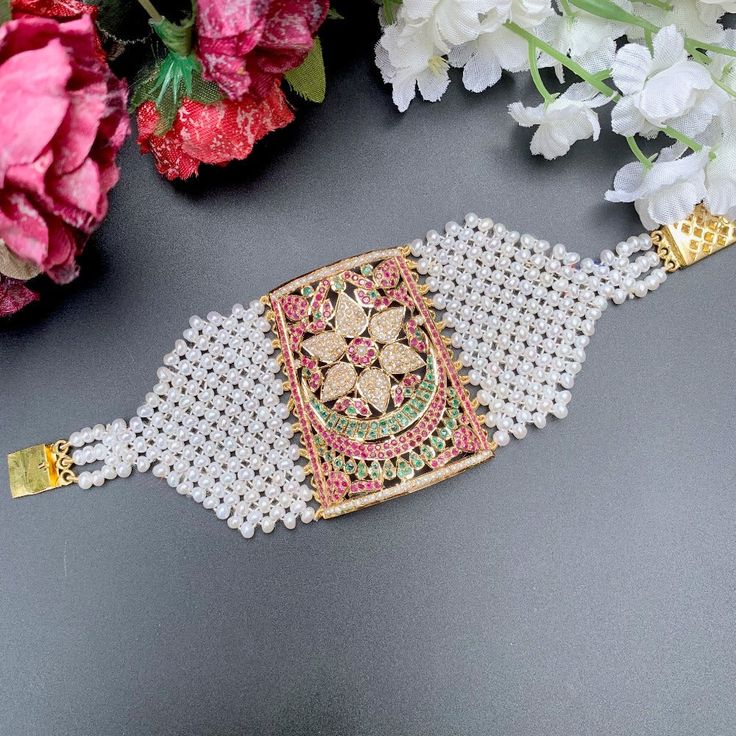 Featuring a traditional punjabi jadau bracelet made in 22ct gold and embellished with finest quality of rubies, emeralds and pearls. The baahi weighs 42.15 GMs including 21.1 GMs of beaded pearls Price Breakup Summary Component Rupees % of Total 22k Gold 109,989 74.6% Stones & Beads 13,274 9.0% Making Charges 19,798 13.4% Taxes (GST) 4,292 3.0% Total 147,353 100.0% View Detailed Price Breakup Watch Video Here Bollywood Style Bracelets With Intricate Design For Receptions, Bollywood Style Bracelets For Reception With Intricate Design, Bollywood Style Intricate Bracelets For Reception, Traditional Kundan Pearl Bracelet For Festive Occasions, Traditional Kundan Pearl Bracelet, Stone Work Bracelets For Diwali Reception, Stone Work Bracelets For Reception And Diwali, Bollywood Bracelets For Diwali Reception, Traditional Hand Set Pearl Bracelet For Festive Occasions