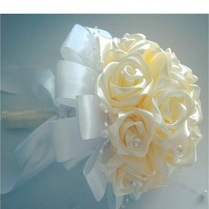 a bridal bouquet with white roses and pearls