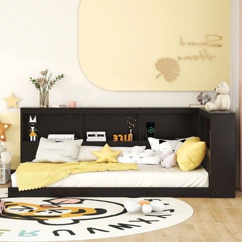 a child's bedroom with yellow and white accessories on the bed, rugs and wall decor