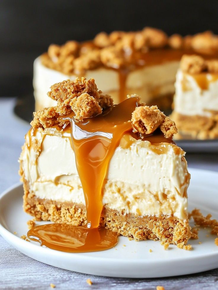 a piece of cheesecake on a plate with caramel drizzle