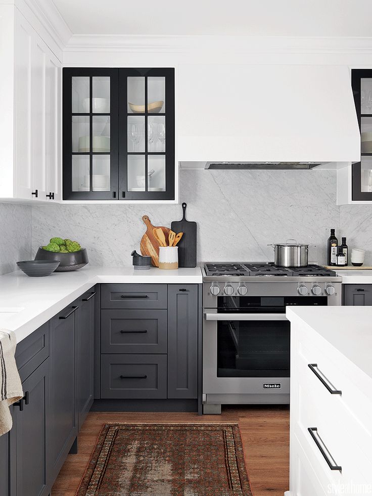 a kitchen with gray cabinets and white counter tops