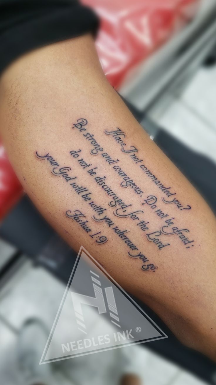 a person with a tattoo on their arm that has words written in cursive writing