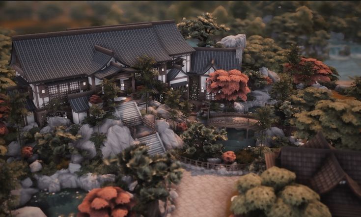 an aerial view of a house surrounded by trees and rocks, with water in the foreground