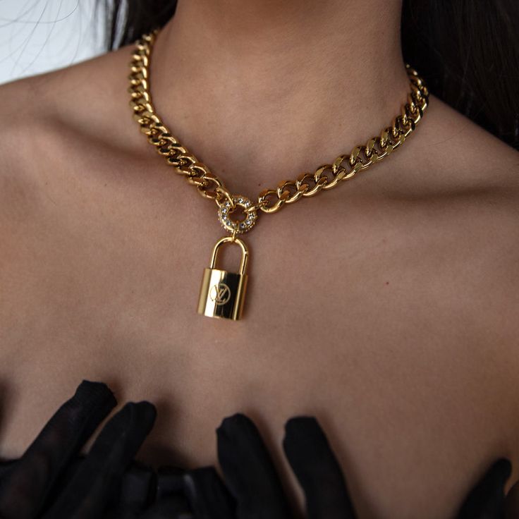 Be bold and stand out with the Tempo Necklace! Featuring a distinct, repurposed lock, this one-of-a-kind statement necklace makes a powerful impression. With its unique design, it'll be sure to turn heads and be noticed wherever you go. -16" length with 2" extender chain -10mm cuban links -18k gold plating over stainless steel cuban link chain -Cubic zirconia stones Lock Chain, Wrist Jewelry, Jewel Necklace, Jewelry Lookbook, Cuban Link Chain, Earring Sale, Cuban Link, Be Bold, Pretty Jewellery