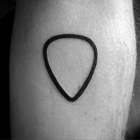 a small black triangle tattoo on the right thigh, with an arrow drawn in it