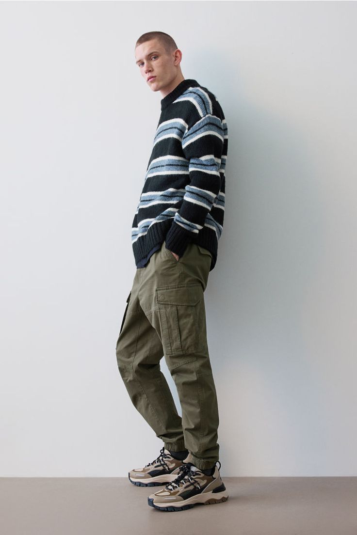 Joggers in woven cotton fabric. Waistband with drawstring and covered elastic. Diagonal side pockets  back pockets with flap and concealed snap fasteners  and leg pockets with flap and concealed snap fasteners. Tapered legs with seams and darts at knees and covered elastic at hems. Cargo Joggers, Snap Fasteners, Green Man, Woven Cotton, Khaki Green, Fashion Company, Tapered Legs, Cotton Weaving, Personal Style