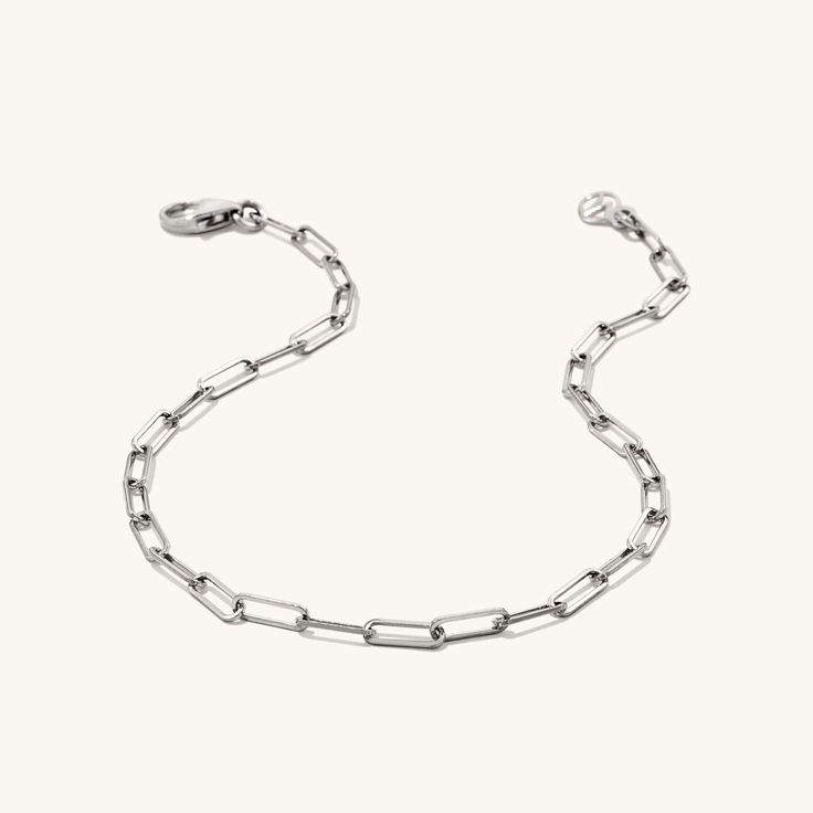 This sleek Narrow Links Bracelet features narrow, delicate links, available in both gold and silver. A versatile piece that effortlessly blends sophistication and style, perfect for layering or wearing solo. Premium Finish Adjustable Size Length 4" - 7" | 101mm - 177mm Tarnish Resistant Hypoallergenic Classic White Gold Paperclip Bracelet For Everyday, Everyday White Gold Chain Link Bracelet, Everyday Chain Bracelet With Rectangular Links, Everyday Silver Chain Bracelet With Rectangular Links, Everyday White Gold Bracelet With Paperclip Chain, Everyday White Gold Paperclip Chain Bracelet, Sterling Silver Bracelet With Rectangular Links And Adjustable Chain, Everyday White Gold Link Chain Bracelet, Everyday White Gold Chain Bracelet With Solid Link