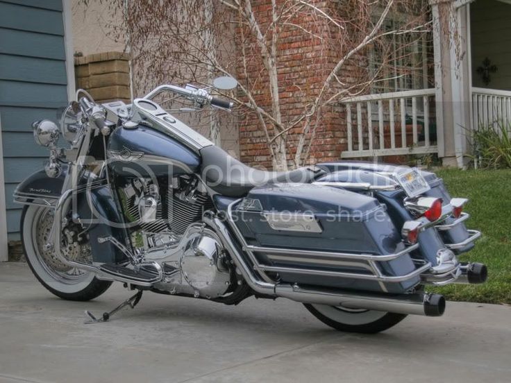 a blue motorcycle parked in front of a house