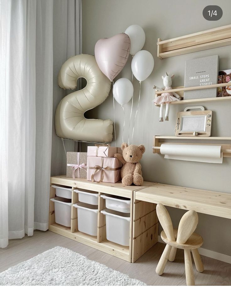 a baby's room with balloons and toys on the shelf, including a teddy bear