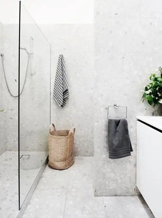 a bathroom with a shower, sink and towel rack