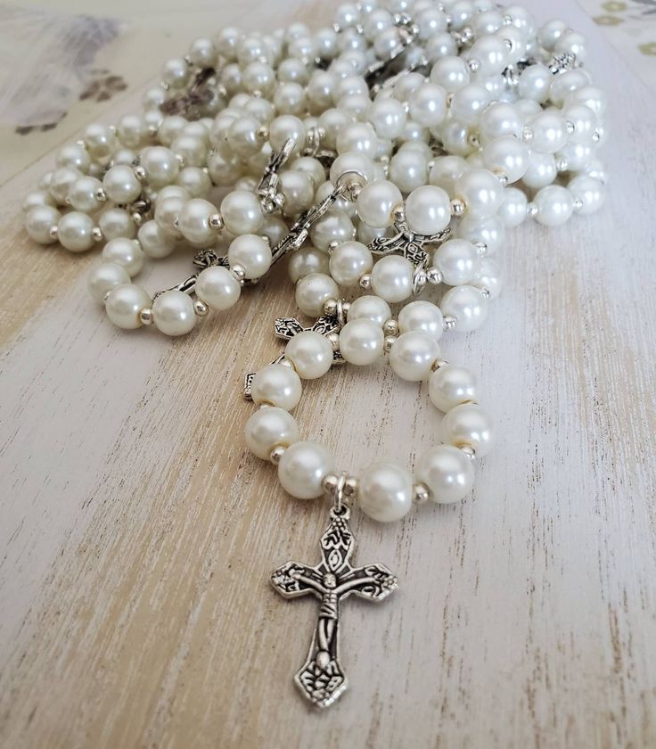 Mini rosary favors for baptism, first communion, etc 8mm white coated glass beads strung onto quality stretch cord with silver tone metal spacers and 1/2 inch cross Please contact me for bulk orders. These are available in other colours and bead materials Silver Beaded Rosary For First Communion, Silver Pearl Rosary With 8mm Beads, Silver Jewelry With 8mm Beads For First Communion, Personalized Silver Rosary For First Communion, Personalized Silver Rosary For Confirmation, Silver Rosary Bracelet With Round Beads For First Communion, 8mm Bead Crucifix Jewelry For First Communion, 8mm Bead Crucifix For First Communion, Silver Baptism Jewelry With 8mm Beads