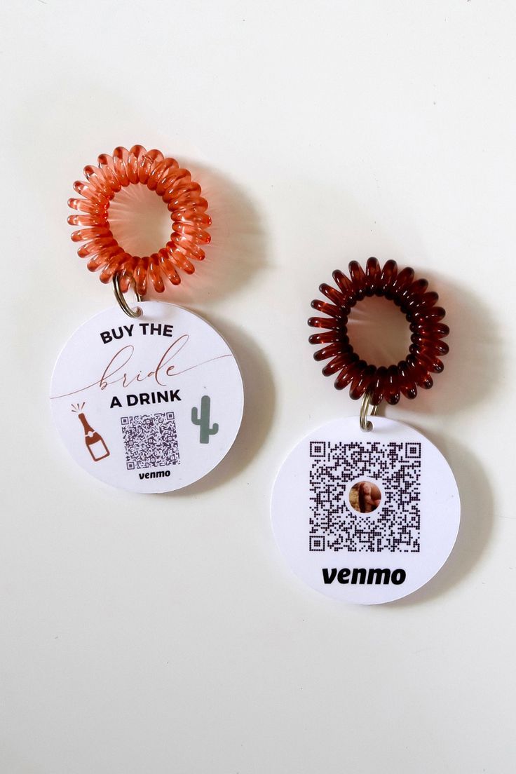 two badges that say buy the drink, ride a drink and vermo on them