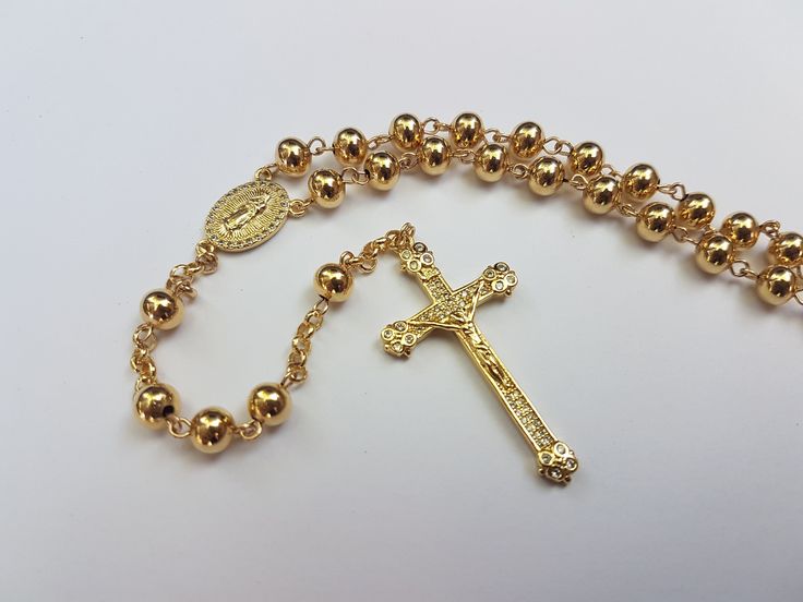 This is a handmade rosary made with entirely with 14k gold-filled material: wire, chain, beads, center, and crucifix. Where gold-plated jewelry is a very light layer of gold - 0.05% actual gold or less, US standards require the gold layer to consist of 1/20th (or 5%) of the jewelry's total weight to be considered GOLD-FILLED. This makes the rosary tarnish-resistant and keeps it shiny over years of use.  - A free velvet pouch can be replaced by a handmade 14k gold-filled-design velvet jewelry box Adjustable Gold Beaded Chain Rosary Bracelet, Adjustable Gold Beaded Rosary Bracelet, Gold Rosary Bracelet With Beaded Chain, Gold Beaded Chain Rosary Bracelet With Round Beads, Gold Rosary Bracelet With Cross And 8mm Beads, Gold Round Beads Rosary As Gift, Gold Rosary With Round Beads As Gift, Gold Beaded Spiritual Rosary Bracelet, Spiritual Gold Rosary Bracelet With Gold Beads