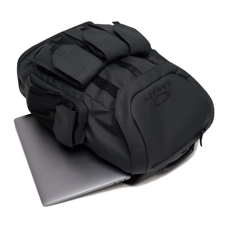 a black backpack sitting on top of a laptop computer bag with its lid open and zippered closures