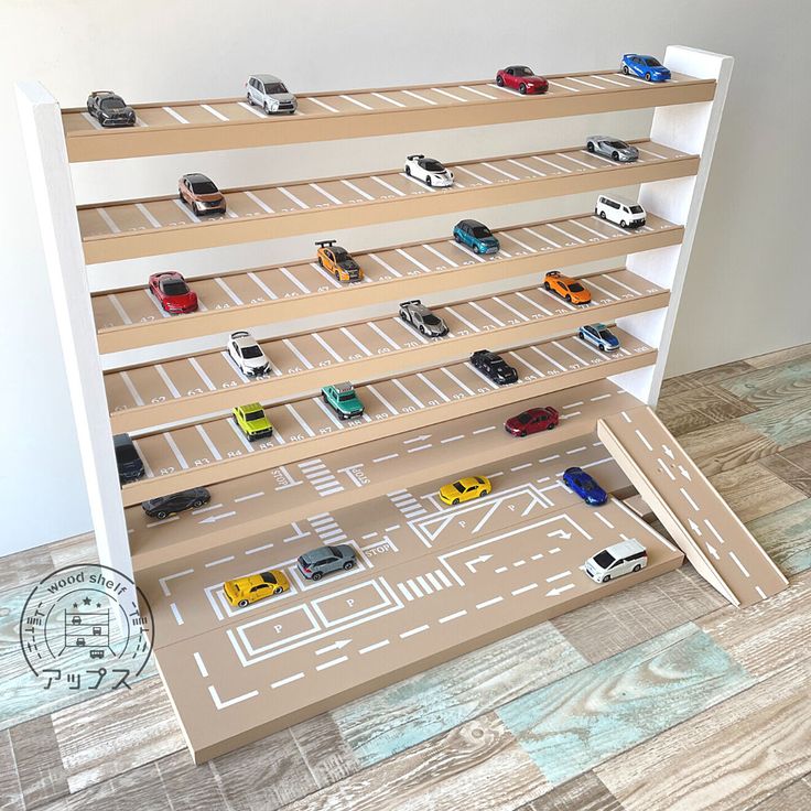 toy cars are lined up on shelves in a playroom with wooden floors and flooring