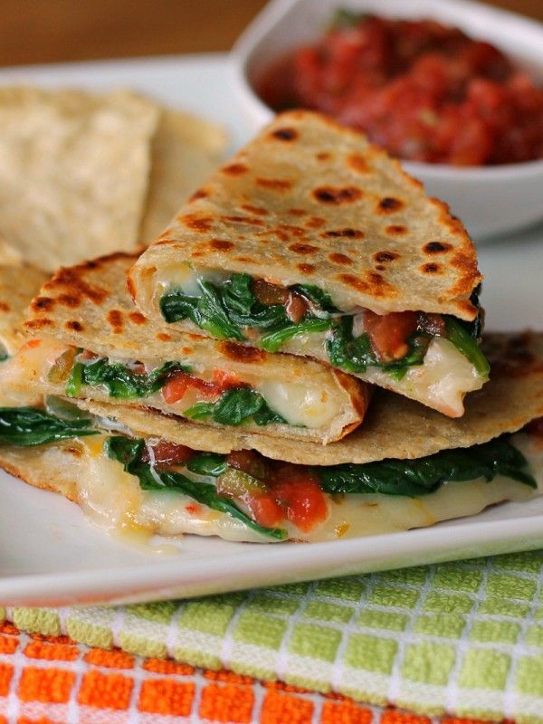 a white plate topped with quesadillas and salsa