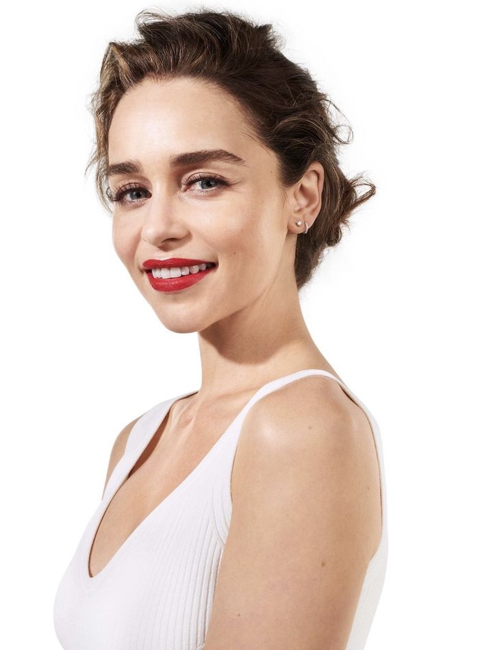 a woman wearing a white top and red lipstick