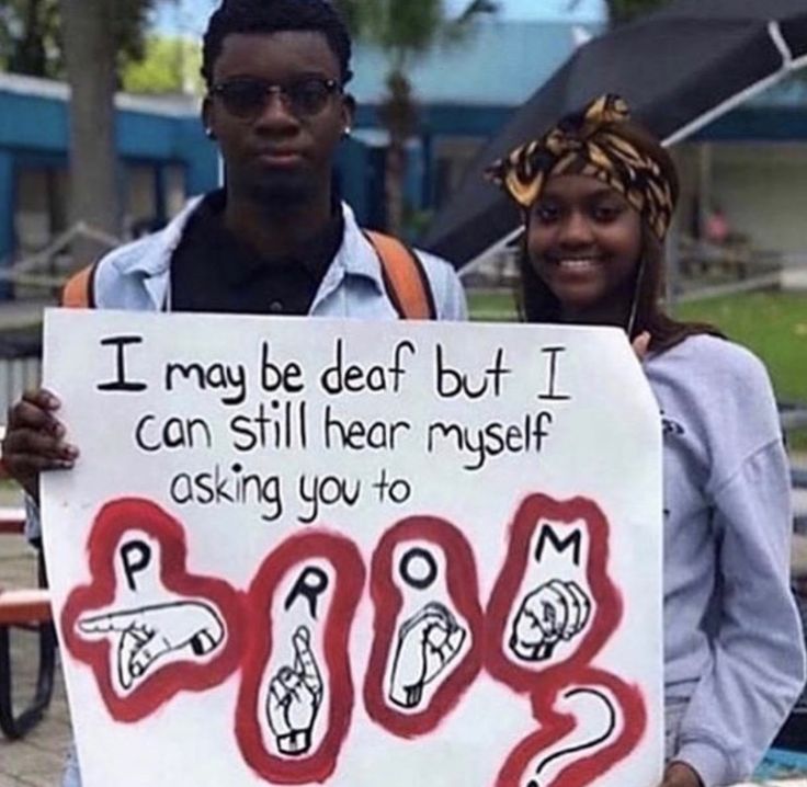 two people holding a sign that says i may be dead but i can still hear my self asking you to boo