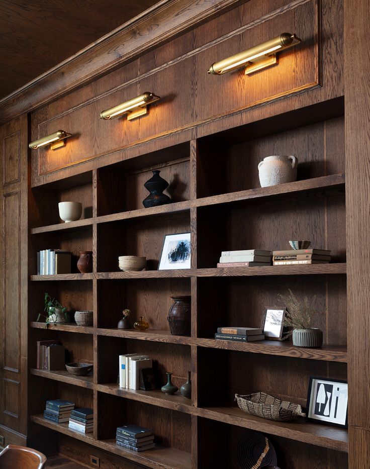 a wooden book shelf filled with lots of books on top of it's sides