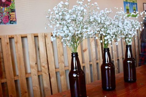 three brown bottles with white flowers in them