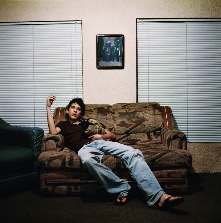 a man sitting on top of a couch in a living room