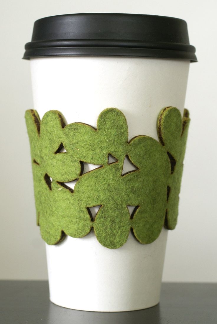 a coffee cup is decorated with green felt