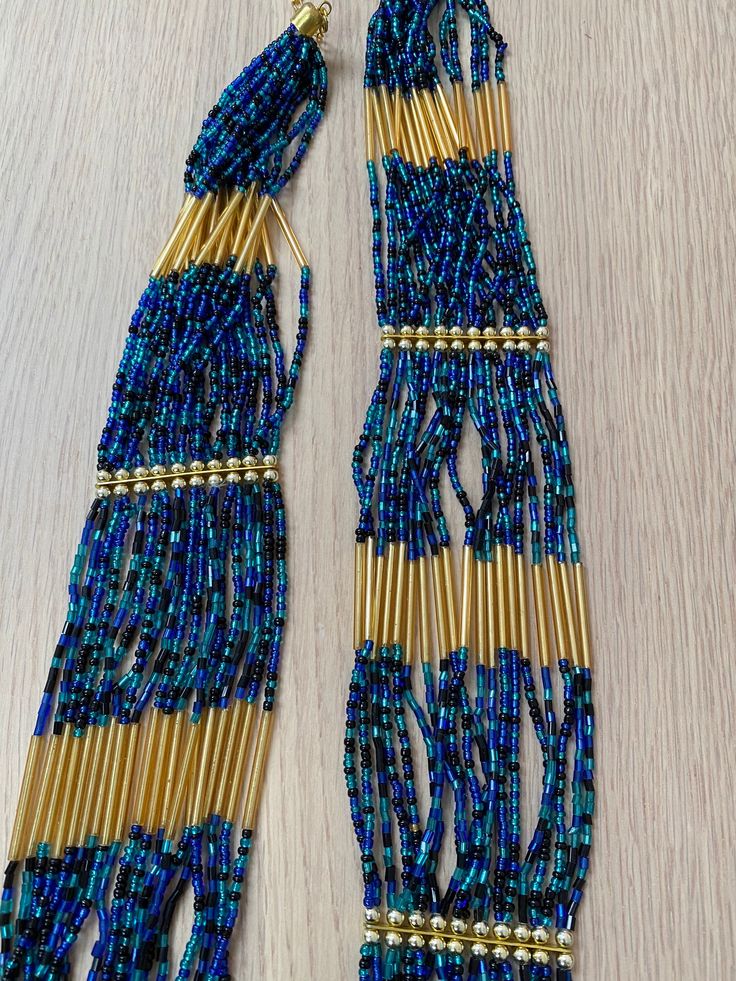 Beaded necklace in blue and gold. Clasp. Handmade in Brazil Handmade Blue Multi-strand Necklace, Bohemian Blue Beaded Necklaces With Gold Beads, Bohemian Blue Beaded Necklace With Gold Beads, Blue Multi-strand Necklace With Polished Beads, Blue Necklaces With Gold Round Beads, Blue Necklace With Gold Round Beads, Blue Multi-strand Necklace With Spacer Beads, Blue Round Bead Necklaces For Festivals, Blue Multi-strand Jewelry With Gold Beads