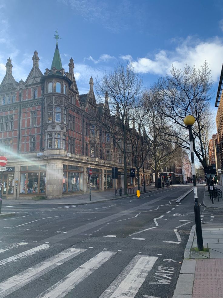 an empty street in front of a large building