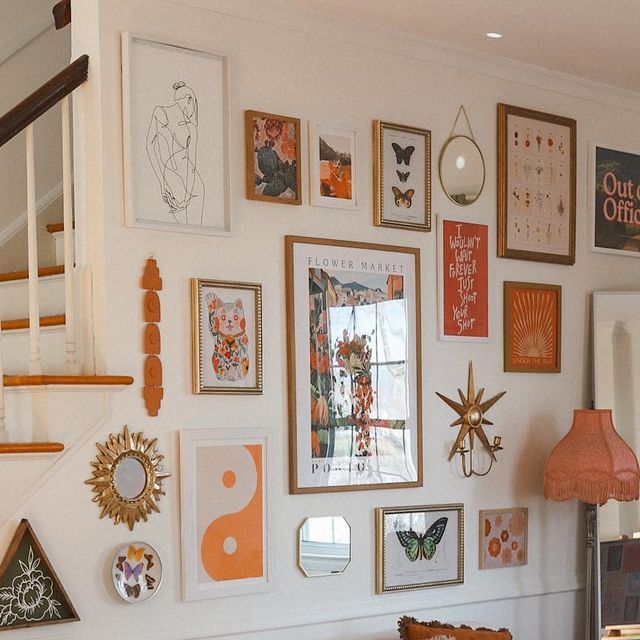 a living room filled with lots of pictures on the wall