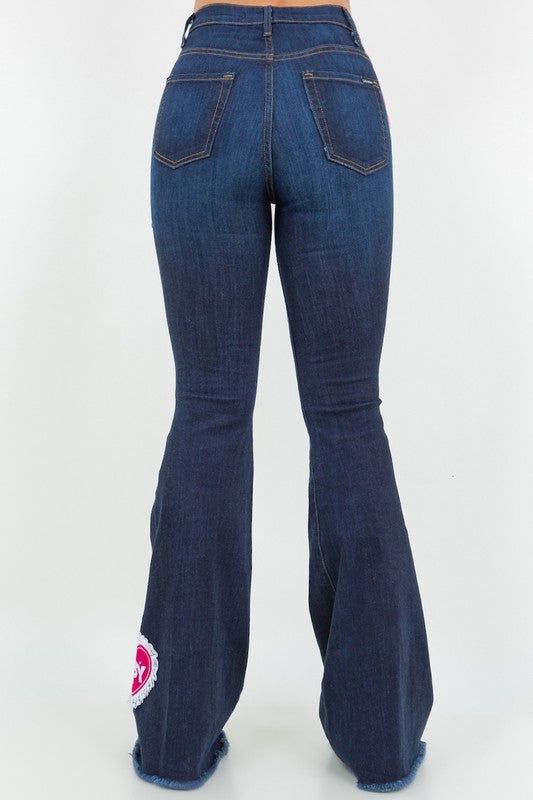 Upgrade your denim wardrobe with our Sweetheart Bell Bottom Jean in Dark Denim! These trendy jeans feature a flattering design with a front button and zipper closure, convenient front and back pockets, and adorable patch and charm accents. Made with premium fabrics in the USA, you can rely on their high-quality.DRY CLEAN ONLY. Silhouette: Bell bottom Fit: High Rise Embellishment: Patches, charms Length: Full Length Closure: button, zipper Made In: USA Fabric Contents: 98% Cotton, 2% Spandex Stre Corset Leggings, Womens Fashion Jeans, Elegant Moments, Trendy Jeans, Stylish Jeans, Bottom Jeans, Jumpsuit Jacket, Leather Denim, Instagram Outfits