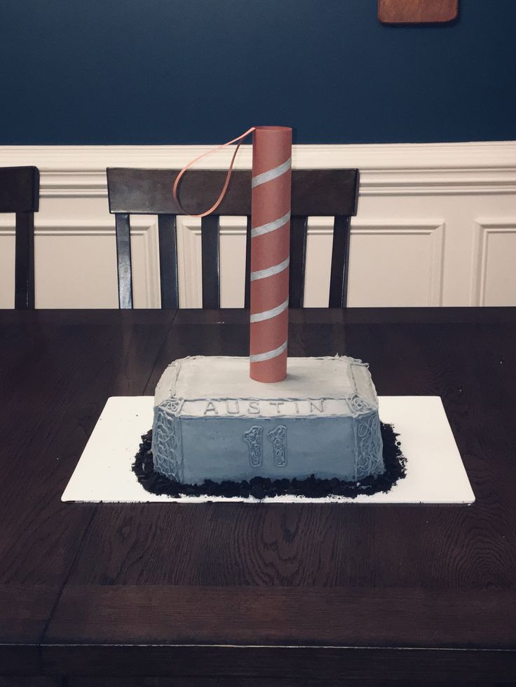 a cake that is sitting on top of a table in the shape of a fire extinguisher