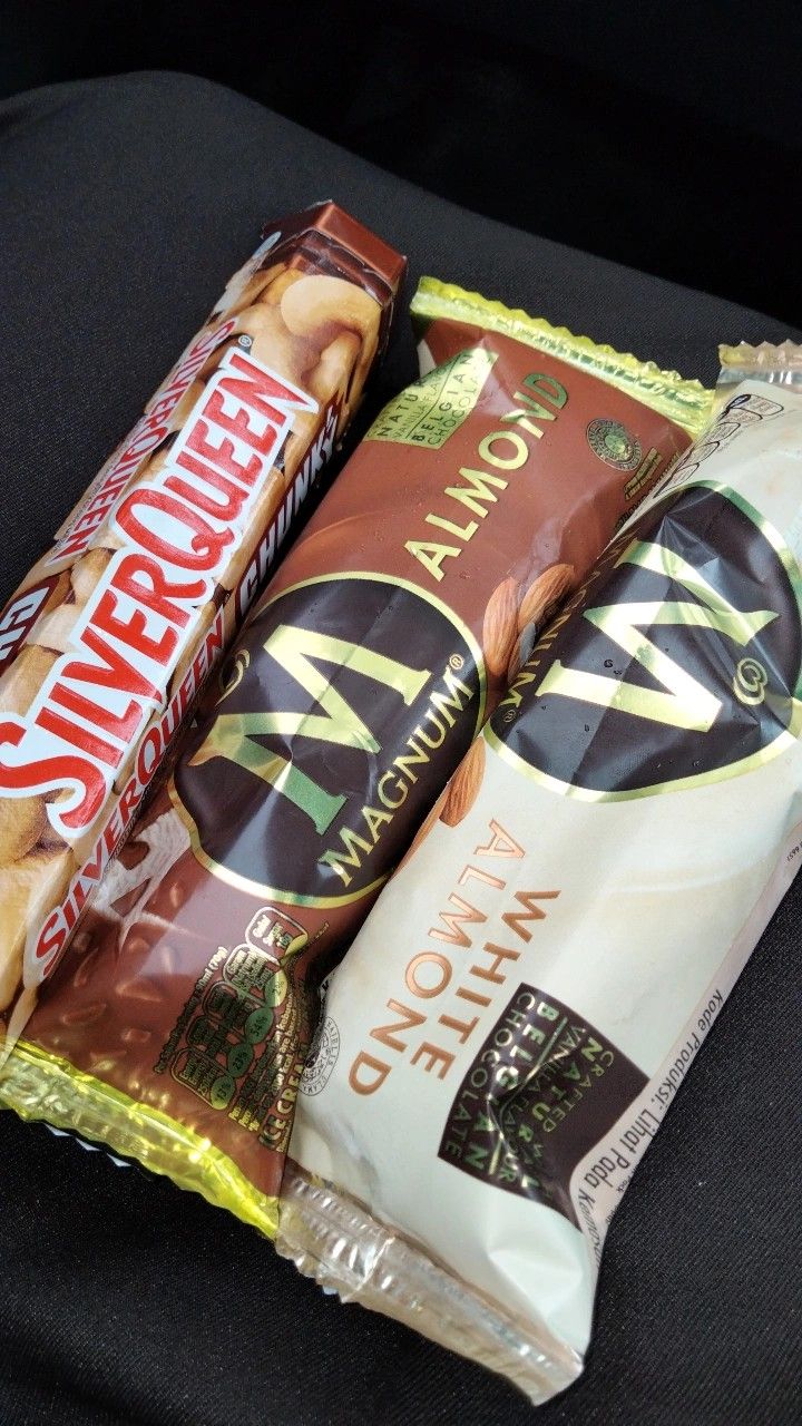 three different types of snacks sitting on top of a black chair next to each other