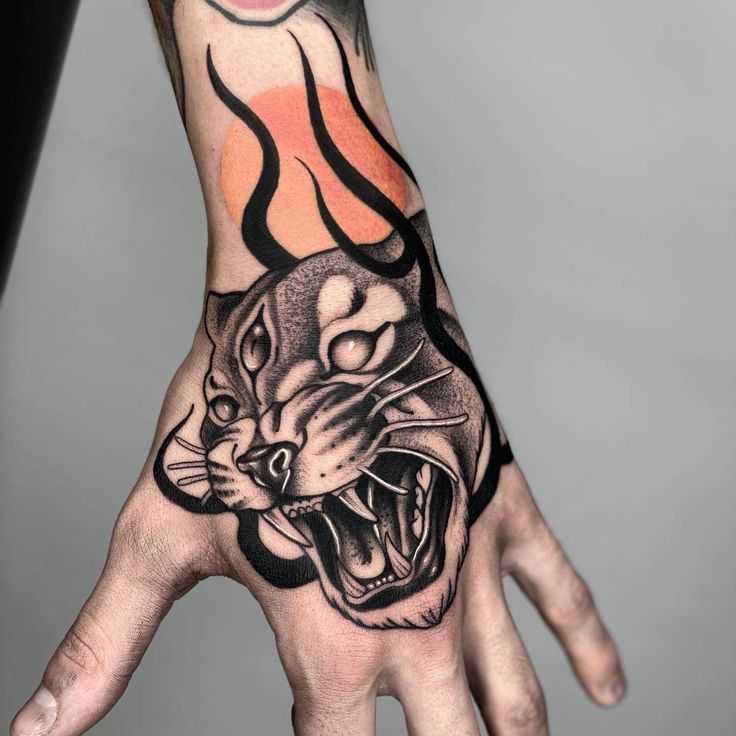 a person's hand with a tattoo on it and a tiger design on the palm