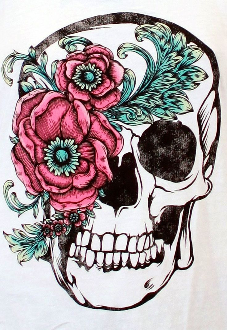 a woman wearing a white tank top with a skull and flowers on the back of it