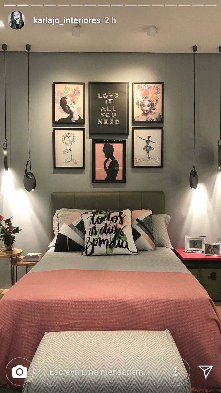 a bed with pink sheets and pillows in a bedroom next to pictures on the wall