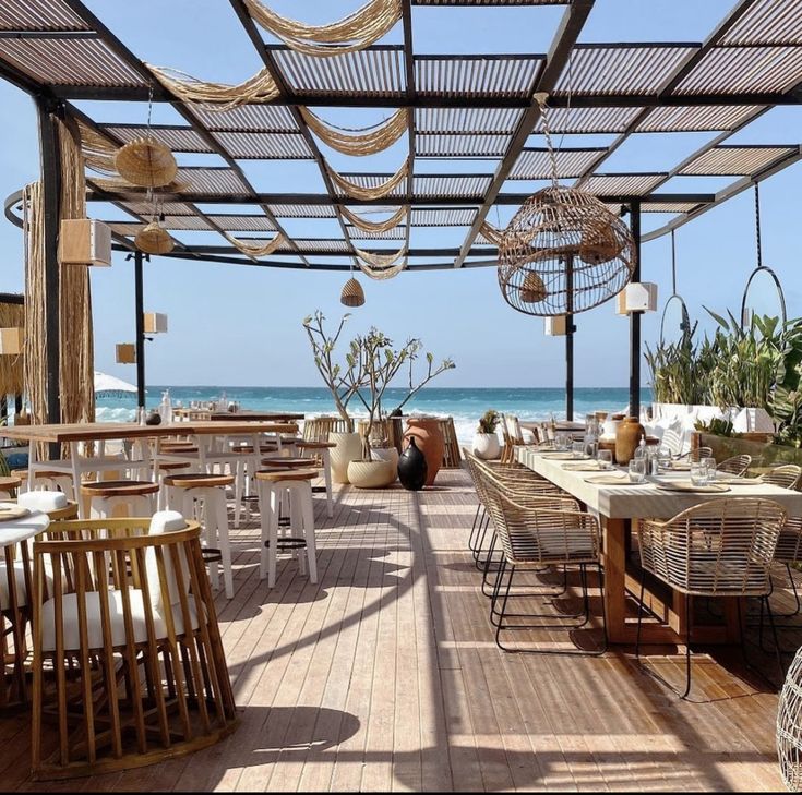 an outdoor dining area overlooking the ocean