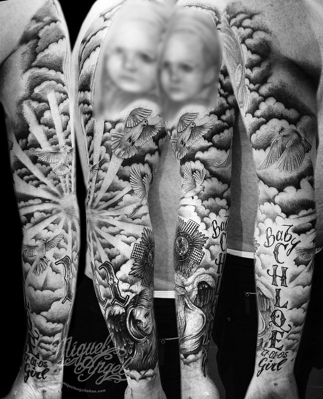 two people with tattoos on their arms and legs are standing in front of each other