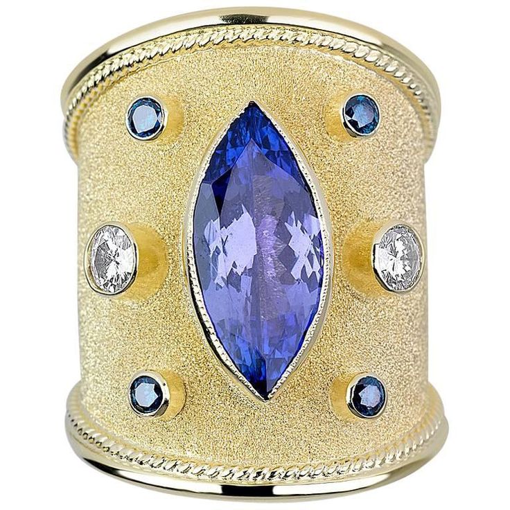 One of a kind S.Georgios design Hand Made 18 Karat Yellow Gold Ring decorated with Byzantine-style granulation and unique velvet look on the background. The ring features a 3.59 Carat Center Marquise Natural Tanzanite, two Brilliant Cut White Diamonds total weight of 0.40 Carat and 4 Brilliant cut Blue Diamonds total weight of 0.22 Carat. The ring is outstanding in quality of workmanship and stone collection and is made in our workshop in Athens Greece. Size: 8 (can be custom made to fit any siz Byzantine Ring, Byzantine Rings, Statement Rings Diamond, Tanzanite Diamond Ring, Tanzanite Diamond, Purple Jewelry, Gold And Silver Rings, Blue Tourmaline, Tourmaline Stone