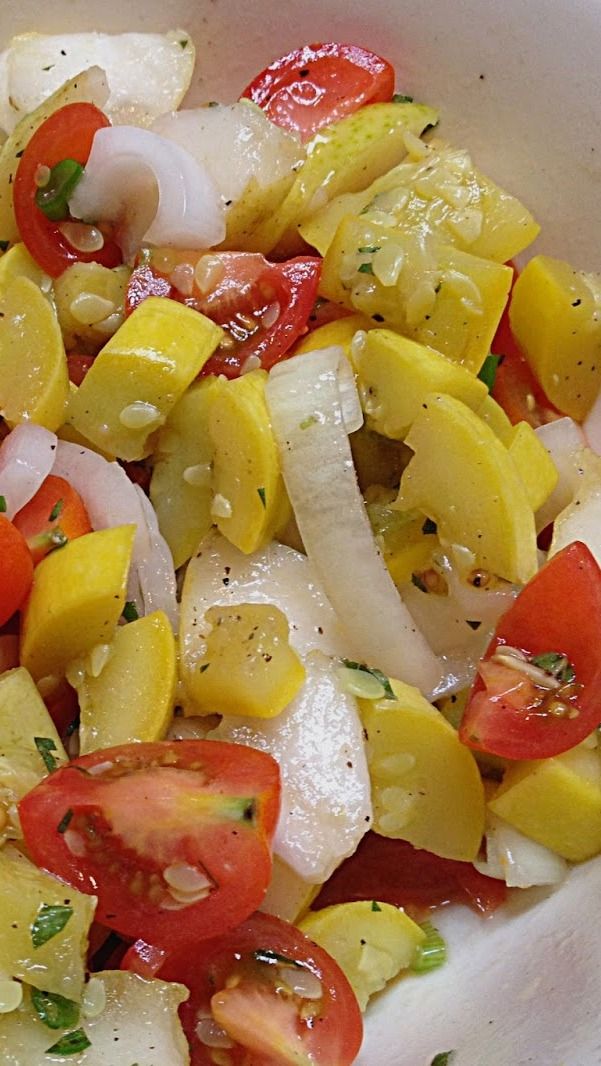 a white bowl filled with lots of different types of food on top of a table