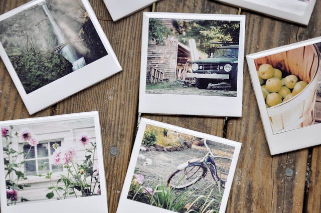 several photographs are arranged on a wooden table with an old truck and fruit bowl in the background