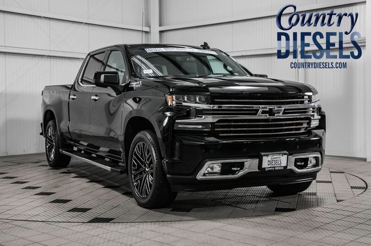 a black chevrolet truck is parked in a garage with the country diesels logo on it