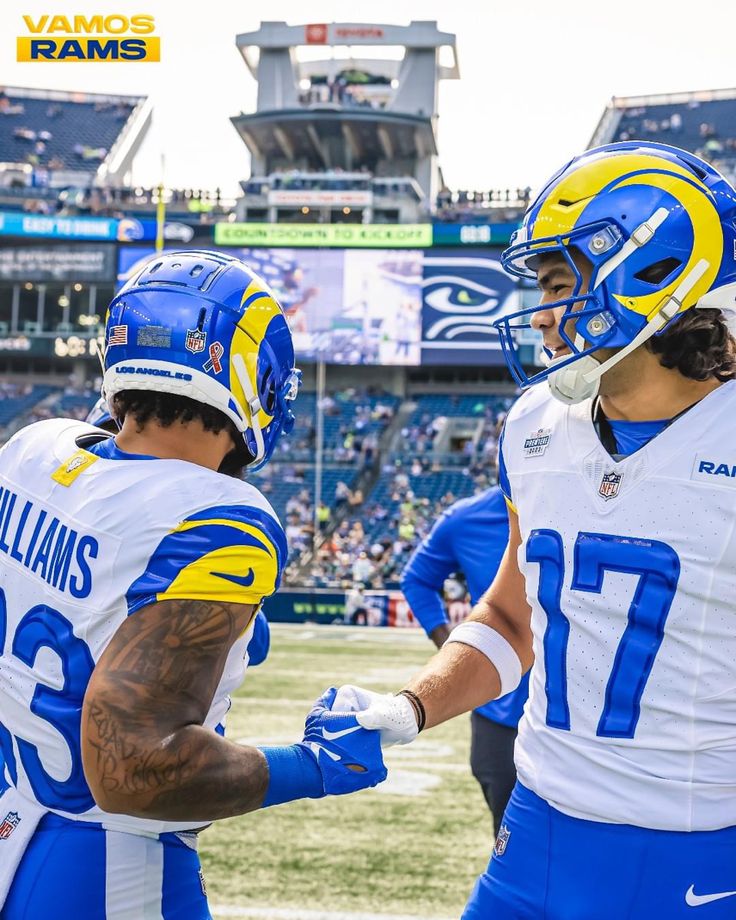 two football players shaking hands on the field