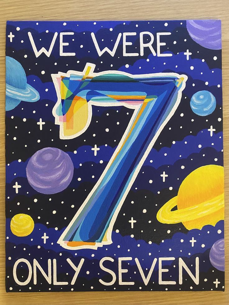 the cover of we were 7 only seven is shown on a wooden surface with space and planets in the background