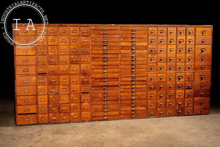 an old wooden filing cabinet with many drawers