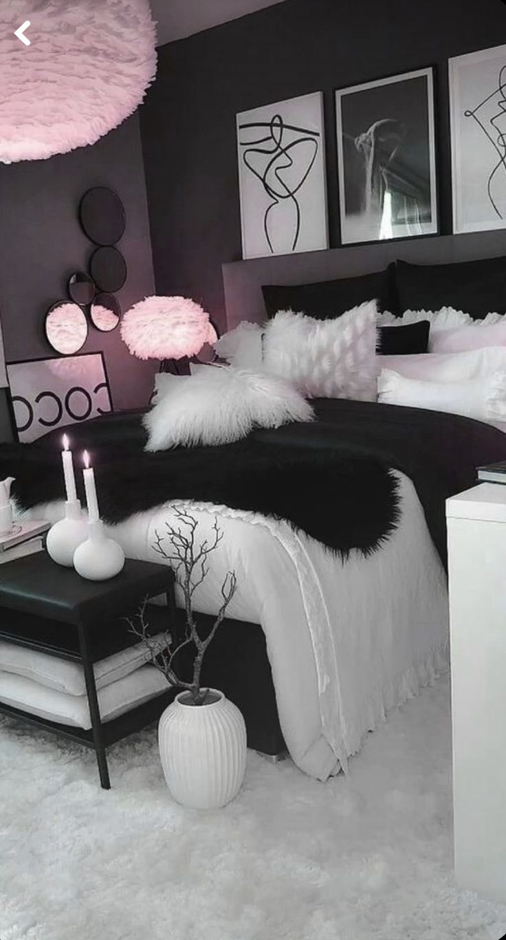 a black and white bedroom with pink accents